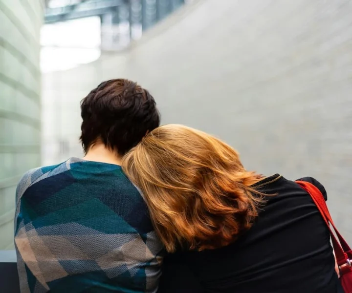 Two people sitting close together in quiet support